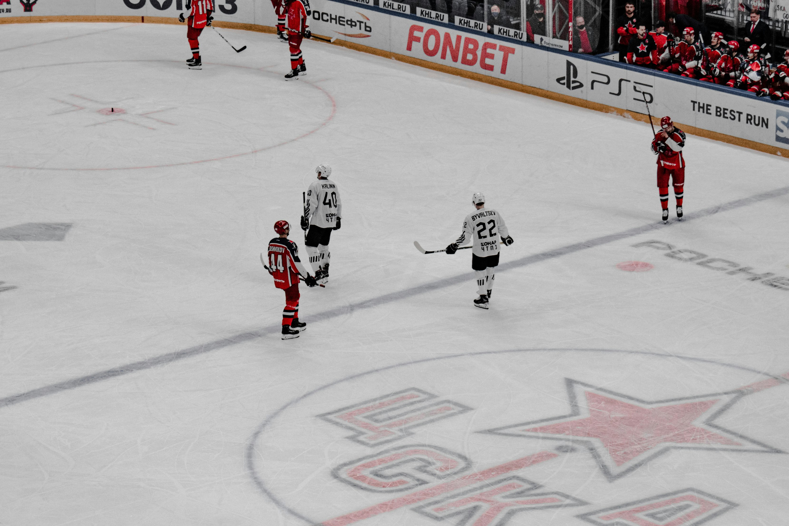 people playing ice hockey on ice hockey field